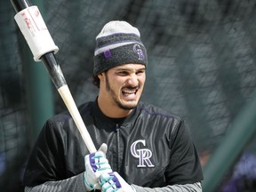 Colorado Rockies' Nolan Arenado waits to take swings in the cage during batting practice before facing the Atlanta Braves in a baseball game Saturday, April 7, 2018, in Denver.