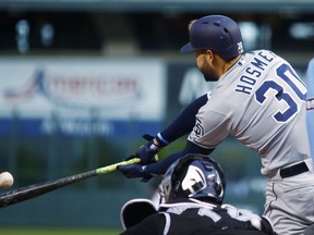 San Diego Padres' Eric Hosmer connects for a single off Colorado Rockies starting pitcher Chad Bettis in the first inning of a baseball game Monday, April 23, 2018, in Denver.