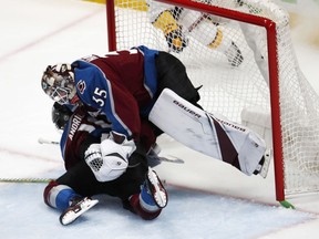Colorado Avalanche right wing Sven Andrighetto, bottom, runs into goaltender Andrew Hammond during the third period against the Nashville Predators in Game 4 of an NHL hockey first-round playoff series Wednesday, April 18, 2018, in Denver. The Predators won 3-2.