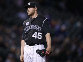 Colorado Rockies relief pitcher Scott Oberg waits to be pulled from the mound after giving up a single to allow in two runs to San Diego Padres' Matt Szczur in the seventh inning of a baseball game, Monday, April 23, 2018, in Denver. The Padres won 13-5.