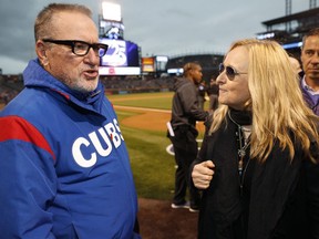 Chicago Cubs manager Joe Maddon, left, chats with singer Melissa Etheridge after she performed the national anthem before the Colorado Rockies played the Cubs in a baseball game Friday, April 20, 2018, in Denver.