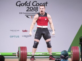 Canada's Boady Santavy reacts after lifting 196kg in the clean and jerk on his way to a silver medal in the men's 94kg weightlifting finals at the Commonwealth Games Sunday, April 8, 2018 in Gold Coast, Australia.