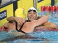 Canada's Kylie Masse, right, gets a hug from Australia's Emily Seebohm after Masse won the gold medal in the women's 100m backstroke at the Commonwealth Games on Saturday, April 7, 2018.