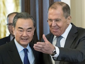 Russian Foreign Minister Sergey Lavrov, right, and China's Foreign Minister Wang Yi enter a hall during their meeting in Moscow, Russia, Thursday, April 5, 2018.