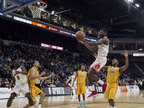 Calgary Dinos' Mambi Diawara, centre, lays up the winning shot in the last seconds of the gold medal game against the Ryerson Rams during the U Sports men's basketball national championship in Halifax on Sunday, March 11, 2018. Canada had a rough start to the Commonwealth Games men's basketball competition Friday, losing 95-55 to powerful Australia. Diawara, with 10 points, was the only Canadian to reach double figures.