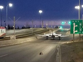 A plane sits on a street after making an emergency landing in Calgary on Wednesday, April 25, 2018.