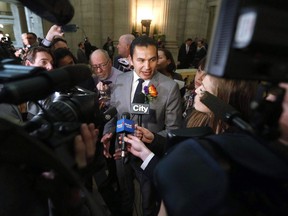 Manitoba opposition leader Wab Kinew speaks to media outside the legislature after the provincial throne speech was read at the Manitoba Legislature in Winnipeg, Tuesday, November 21, 2017. Kinew says his New Democrats will delay the province's proposed carbon tax law.