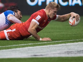 Canada's John Moonlight, right, scores the winning try in the final moments of play as France's Jean Baptiste Mazoue tries to stop him during World Rugby Sevens Series' Canada Sevens bowl final action, in Vancouver on March 13, 2016. John Moonlight, a rugby icon who led Canada to some of its greatest sevens triumphs, is retiring to become a firefighter in his native Pickering, Ont. The 30-year-old Moonlight leaves as Canada's all-time caps leader in sevens. He played in 65 World Series events, scoring his 116th career try in Hong Kong prior to representing Canada earlier this month at the Commonwealth Games in Australia.