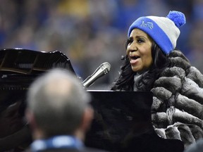 In this Nov. 24, 2016, file photo, Aretha Franklin performs the national anthem before an NFL football game between the Detroit Lions and the Minnesota Vikings in Detroit. Aretha Franklin is cancelling her rescheduled Toronto concert on doctor's orders.