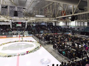 Flowers lie at centre ice as people gather for a vigil at the Elgar Petersen Arena, home of the Humboldt Broncos, to honour the victims of a fatal bus accident in Humboldt, Sask. on April 8, 2018. What has become a symbol of grief following the Humboldt Broncos bus crash earlier this month is about to be taken down. The ring around centre ice at Humboldt's Elgar Petersen Arena became a memorial lined with flowers and other tributes soon after the April 6 crash that killed 16 people and injured another 13. The tribute has grown since then, but the City of Humboldt says with summer approaching the ice must come out and work to remove it will begin Friday morning.