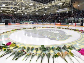 Flowers lie at centre ice as people gather for a vigil at the Elgar Petersen Arena, home of the Humboldt Broncos, to honour the victims of a fatal bus accident in Humboldt, Sask. on Sunday, April 8, 2018. It will take several months to distribute the more than $8 million raised so far for the victims of a fatal bus crash involving the Humboldt Broncos, says the platform hosting the online crowdfunding campaign -- the largest ever in Canada.