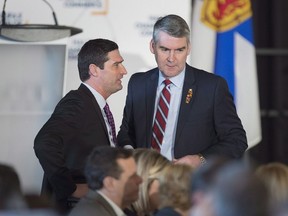 Premier Stephen McNeil, right, chats with Geoff MacLellan, government house leader, before he delivers the state-of-the-province speech at a business luncheon in Halifax on Wednesday, Feb. 7, 2018. Nova Scotia is modernizing outdated parts of its marriage laws by, among other things, removing references to spinsters and illegitimate children.