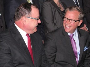 Saskatchewan Premier Brad Wall and Bill Boyd share a laugh in Regina in a May 25, 2012 file photo. Former Saskatchewan cabinet minister Boyd has been fined for environmental violations.THE CANADIAN PRESS/Jennifer Graham