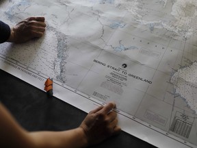 Researchers look over a map aboard the Finnish icebreaker MSV Nordica as it sets sail in the North Pacific Ocean toward the Bering Strait to traverse the Arctic's Northwest Passage on July 6, 2017. The Canadian government wants more study on the impacts of banning heavy fuel oil in the Arctic before it signs on to an international agreement to do so. It has been 16 months since Prime Minister Justin Trudeau and then U.S. President Barack Obama jointly committed to phase down the use of heavy fuel oils in the Arctic.