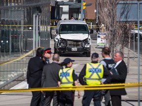 Police are seen near a damaged van after it mounted a sidewalk crashing into a number of pedestrians in Toronto on Monday, April 23, 2018. Think before you post, social media experts say after an uproar emerged over messages that expressed sorrow over Toronto's deadly van tragedy while also appearing to promote shoes and hot yoga.