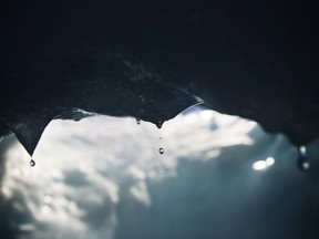 Drops of water fall off an iceberg melting in the Nuup Kangerlua Fjord near Nuuk in southwestern Greenland, Tuesday Aug. 1, 2017. More than four in 10 Canadians surveyed about climate change last month said there is conclusive evidence climate change is real, that it is being caused by people and believe the government should make addressing the problem one of its top priorities.