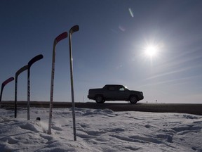 Hockey sticks to remember members of the Humboldt Broncos are silhouetted against the morning sun along a stretch of highway 6 in Saskatchewan, Friday, April, 13, 2018. Today there is a public memorial for 18-year old Parker Tobin, 20-year-old Jaxon Joseph, 18-year-old Logan Hunter and 21-year-old Stephen Wack, players with the SJHL Humboldt Broncos who were among those killed when the team bus and a semi-truck collided at an intersection in rural Saskatchewan.
