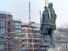 Contractors remove the statue of Edward Cornwallis, a controversial historical figure, in a city park in Halifax on Wednesday, Jan. 31, 2018. Cornwallis, the military officer who founded Halifax in 1749, offered a cash bounty to anyone who killed a Mi'kmaw person.