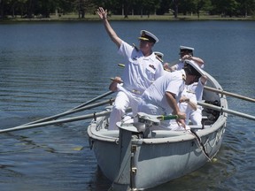 Royal Canadian Navy Vice-Admiral Mark Norman waves goodbye as he is traditionally rowed away in a whaler after stepping down as the head of the Royal Canadian Navy in a ceremony Thursday, June 23, 2016 in Ottawa. One of the military's most senior officers is slated to face accusations in court today that he broke the law by leaking sensitive information to a Quebec shipyard.