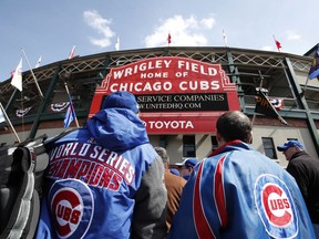 Chicago Cubs' fans line up outside Wrigley Field prior to the start of the Cubs' home opener baseball game against the Pittsburgh Pirates Tuesday, April 10, 2018, in Chicago.
