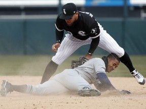 Chicago White Sox second baseman Yoan Moncada, top, tags out Tampa Bay Rays Mallex Smith during the ninth inning of a baseball game in Chicago, on Tuesday, April 10, 2018. The Rays won the game 6-5.