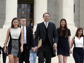 Deputy Attorney General Rod J. Rosenstein departs the Supreme Court on Monday, April 23, 2018, in Washington, with his family, after arguing his first case before the court. He was defending the government's position in a case involving the prison sentence for a convicted drug dealer.