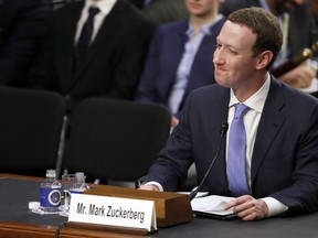 Facebook CEO Mark Zuckerberg reacts to a question about the hotel he stayed in last night as he testifies before a joint hearing of the Commerce and Judiciary Committees on Capitol Hill in Washington, Tuesday, April 10, 2018, about the use of Facebook data to target American voters in the 2016 election.