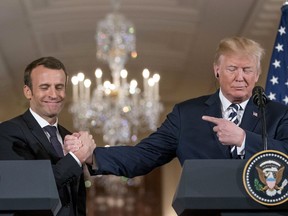 President Donald Trump and French President Emmanuel Macron shake hands during a news conference in the East Room of the White House in Washington, Tuesday, April 24, 2018.