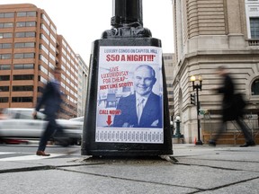 A sign criticizing Environmental Protection Agency Administrator Scott Pruitt is seen posted on the base of a utility pole on the corner of H Street NW and 13 Street NW in Washington, Friday, April 6, 2018.