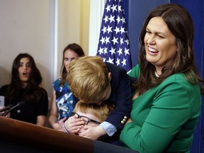 White House press secretary Sarah Huckabee Sanders holds her children during a briefing held for "Take our Daughters and Sons to Work Day" in the briefing room of the White House, Thursday, April 26, 2018, in Washington.