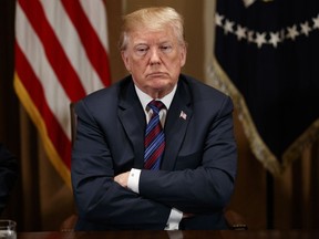 President Donald Trump listens during a meeting with governors and lawmakers in the Cabinet Room of the White House, Thursday, April 12, 2018, in Washington.