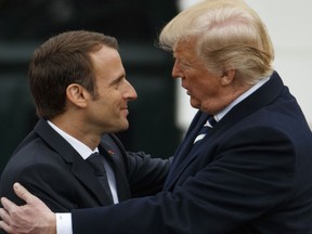 President Donald Trump hugs French President Emmanuel Macron during a State Arrival Ceremony on the South Lawn of the White House, Tuesday, April 24, 2018, in Washington.