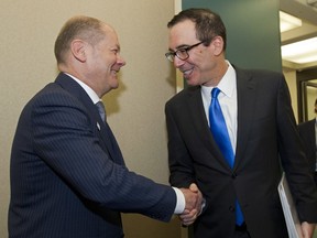 Treasury Secretary Steve Mnuchin, right, shake hands with German Finance Minister Olaf Scholz during a bilateral meeting on the sidelines of the World Bank/IMF Spring Meetings, in Washington, Friday, April 20, 2018.