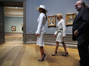 First lady Melania Trump, left, and Brigitte Macron, wife of French President Emmanuel Macron, tour the Cezanne exhibit at the National Gallery of Art, Tuesday April 24, 2018, in Washington. At right is Frank Kelly, with the museum.