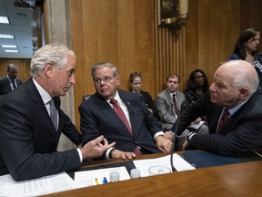 From left, Senate Foreign Relations Committee Chairman Bob Corker, R-Tenn., and Sen. Bob Menendez, D-N.J., the ranking member, and Sen. Ben Cardin, D-Md., confer before the vote on President Donald Trump's nominee for secretary of state, Mike Pompeo, who has faced considerable opposition before the panel, on Capitol Hill in Washington, Monday, April 23, 2018.