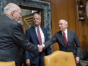 From left, Sen. Patrick Leahy, D-Vt., and Chairman Jerry Moran, R-Kan., welcome Attorney General Jeff Sessions, as he arrives at a Senate Appropriations subcommittee to review budget requests for the Department of Justice, on Capitol Hill in Washington, Wednesday, April 25, 2018. It's his first appearance before Congress in five months and is expected to also face questions on the Russia probe and other matters.