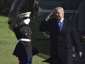 President Donald Trump salutes as he walks off of Marine One on the South Lawn of the White House in Washington, Thursday, April 5, 2018, after returning from a trip to West Virginia.