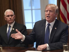 President Donald Trump, right, sitting next to Vice President Mike Pence, left, speaks in the Cabinet Room of the White House in Washington, Monday, April 9, 2018, at the start of a meeting with military leaders.