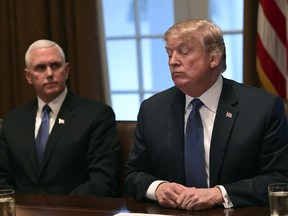 President Donald Trump, right, sitting next to Vice President Mike Pence, left, speaks in the Cabinet Room of the White House in Washington, Monday, April 9, 2018, at the start of a meeting with military leaders.