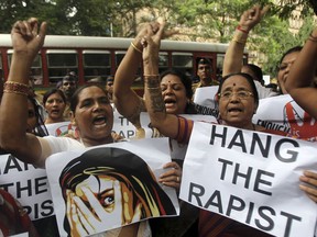 FILE - In this Aug 23, 2013 file photo, Indian activists hold placards demanding rapists be hanged as they protest against the gang rape of a 22-year-old woman photojournalist in Mumbai India. India's government has decided to prescribe the death penalty for people convicted of raping girls under the age of 12 to combat an increase in crimes against women. The Press Trust of India news agency reported Saturday, April 21, 2018, that the ordinance is being sent to the president for approval. It will require the approval of Parliament within six months in order the become law.