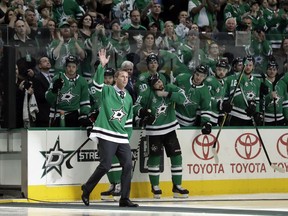 Former Dallas Stars player Mike Modano acknowledges cheers from fans during a pregame ceremony where Modano was honored before a NHL hockey game against the Minnesota Wild in Dallas, Saturday, March 31, 2018.