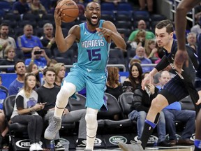 Charlotte Hornets' Kemba Walker (15) looks for a shot as he gets around Orlando Magic's Mario Hezonja (8) during the first half of an NBA basketball game Friday, April 6, 2018, in Orlando, Fla.