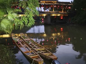 Two dragon boats that capsized sit in the water on the Taohua River in Guilin in southern China's Guangxi Zhuang Autonomous Region, Saturday, April 21, 2018. Chinese state media said that several people have died and others are missing after two dragon boats capsized in southern China, causing dozens of people to fall into the water.