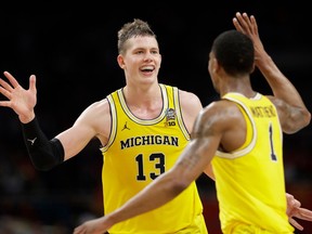 Michigan's Moritz Wagner (13) celebrates with Charles Matthews (1) during the second half in the semifinals of the Final Four NCAA college basketball tournament against Loyola-Chicago, Saturday, March 31, 2018, in San Antonio.