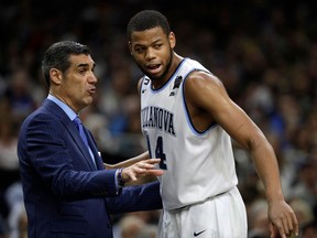 Villanova head coach Jay Wright, left, talks with forward Omari Spellman during the first half against Michigan in the championship game of the Final Four NCAA college basketball tournament, Monday, April 2, 2018, in San Antonio.