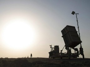 An Israeli soldier walks next to an Iron Dome rocket defense battery near the southern city of Sderot, Israel, in 2015.