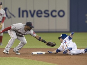 Toronto Blue Jays' Steve Pearce slides safely into second with a double as Boston Red Sox's Eduardo Nunez just misses with the tag during first inning American League MLB baseball action in Toronto on Wednesday April 25, 2018.