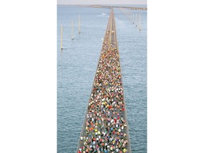 In this aerial photo provided by the Florida Keys News Bureau, runners fan out over Florida Keys waters during the Seven Mile Bridge Run Saturday, April 14, 2018, near Marathon, Fla. The race over the convergence of the Atlantic Ocean and Gulf of Mexico was initiated in 1982 to mark the completion of a federally funded bridge rebuilding program to replace 37 aging spans originally built in the early 1900s to carry railroad trains.