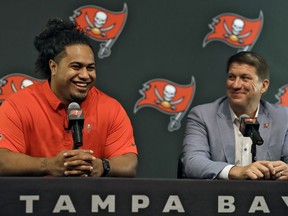 Tampa Bay Buccaneers NFL football first-round draft pick Vita Vea, left, smiles as he sits with general manager Jason Licht during a news conference Friday, April 27, 2018, in Tampa, Fla. Vea, a defensive lineman, played his college football at Washington.