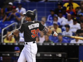 Miami Marlins' Derek Dietrich hits a home run in the first inning of a baseball game against the Chicago Cubs in Miami, Saturday, March 31, 2018. (AP Photo/Gaston De Cardenas)